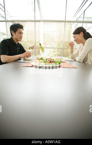 Young couple sitting at the dining table Stock Photo