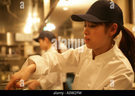Side profile of a female chef working Stock Photo