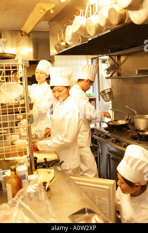Three female chefs and one male chef in the kitchen Stock Photo