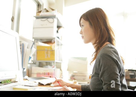 Side profile of a businesswoman working on a computer Stock Photo