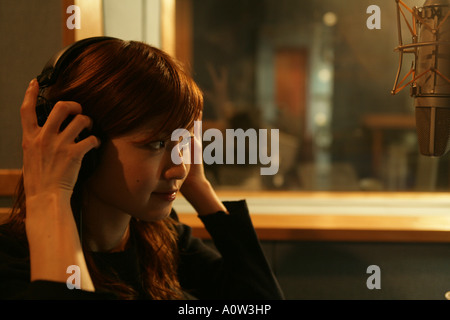Side profile of a young woman in a recording studio Stock Photo