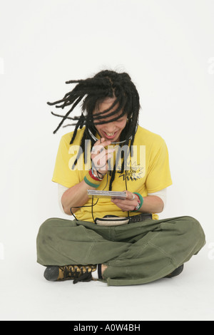 Young man listening to music and smiling Stock Photo