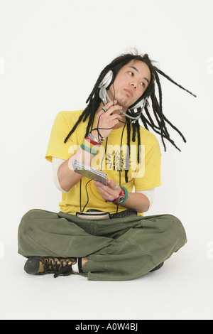 Young man wearing headphones and listening to music Stock Photo