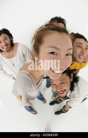 High angle view of a young woman smiling with four young men Stock Photo