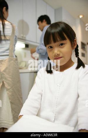 Portrait of a girl carrying a stack of folded towels Stock Photo - Alamy