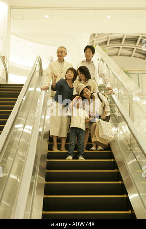 Low angle view of a three generation family on an escalator in a shopping mall Stock Photo