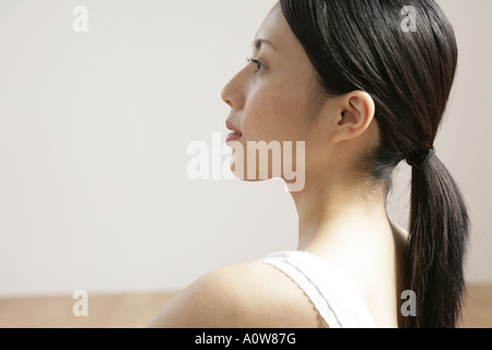 Close up of a young woman looking away Stock Photo