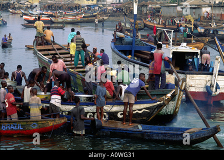 The harbor crowded with traditional fishing boats in Elmina Ghana Stock Photo