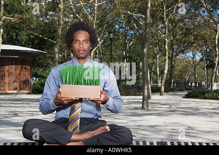 Man meditating in a park Stock Photo