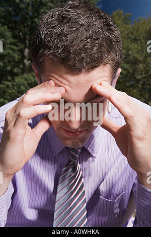Stressed male office worker Stock Photo