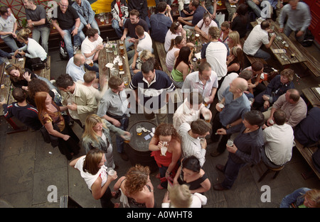 United Kingdom, England, London. Tourists and Londoners drinking at the Punch and Judy pub in Covent Garden Stock Photo