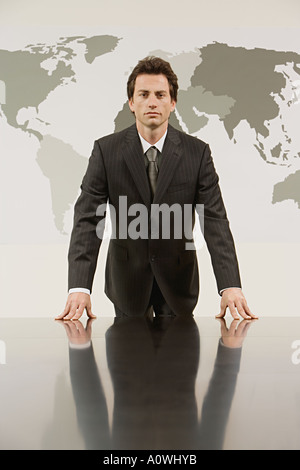 Businessman in front a map of the world Stock Photo
