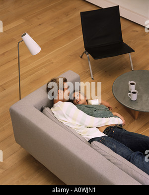 Couple lying on the sofa Stock Photo