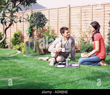 Young couple having coffee in the garden Stock Photo