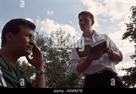 United Kingdom, England, London.Young Christian evangelist with bible and bemused bystander at Speakers Corner in Hyde Park Stock Photo