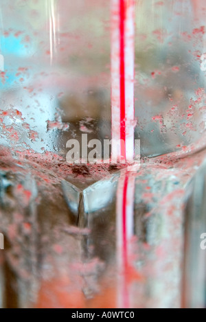 Empty dirty glass and red and white striped straw Stock Photo