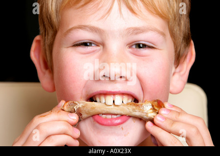 Young Boy Eating Turkey Drumstick Model Released Stock Photo