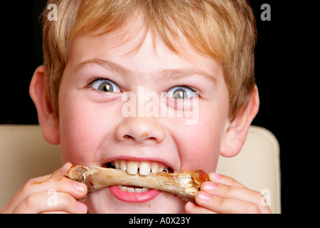 Young Boy Eating Turkey Drumstick Model Released Stock Photo