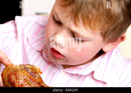 Young Boy Eating Turkey Drumstick Model Released Stock Photo