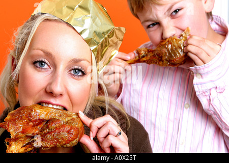 Mother and Son Eating Turkey Drumsticks Models Released Stock Photo