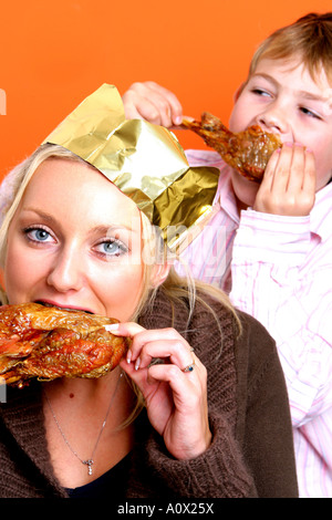 Mother and Son Eating Turkey Drumsticks Models Released Stock Photo