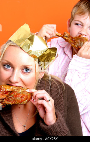 Mother and Son Eating Turkey Drumsticks Models Released Stock Photo