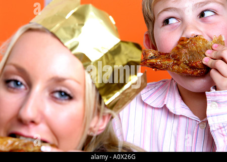 Mother and Son Eating Turkey Drumsticks Models Released Stock Photo