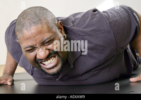 Man working out doing push-ups. Exercise is important for a healthy body and healthy mind. Stock Photo