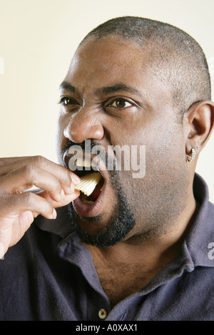 Overweight man eats, and eats, and eats. Stock Photo