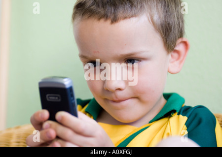 Boy playing with a Nokia mobile phone Stock Photo