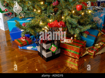 Christmas presents under the Tree on hardwood oak floor Stock Photo