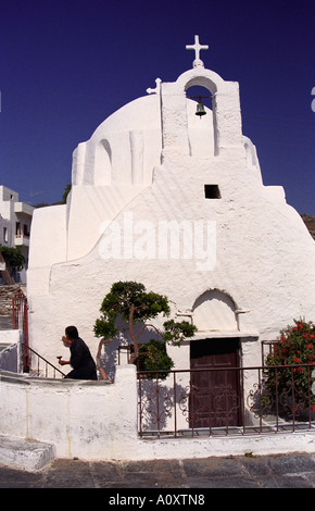 Ios Island, Greece.  Woman carrying incense at a small church in Ios town Stock Photo