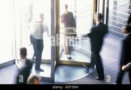 High angle view of business executives walking through a revolving door Stock Photo