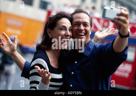 Mid adult couple taking a photograph of themselves Stock Photo
