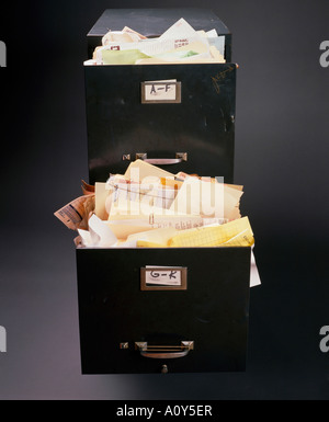 Close Up Of Filing Cabinet With Messy Piles Of Papers Stock Photo