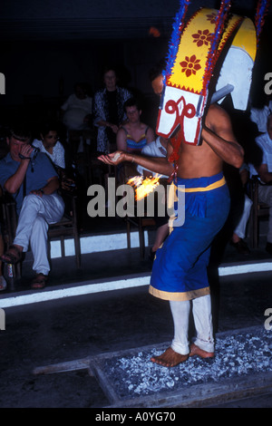 Sri Lankan man performs a traditional dance and fire eating routine Stock Photo