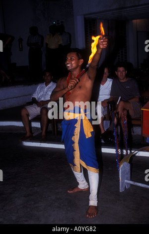 Sri Lankan man performs a traditional dance and fire eating routine Stock Photo
