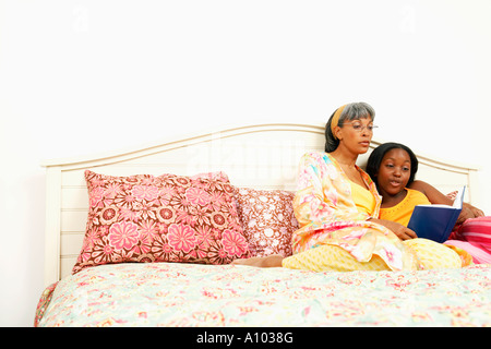 Middle-aged African woman reading with daughter Stock Photo