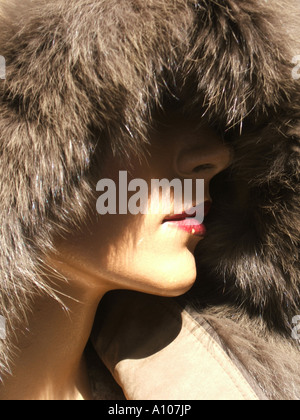 female mannequin wearing fur coat in shop window Stock Photo