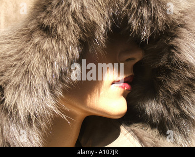 female mannequin wearing fur coat in shop window Stock Photo