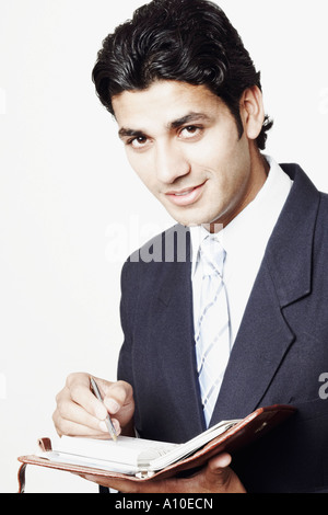 Portrait of a businessman holding a personal organizer Stock Photo