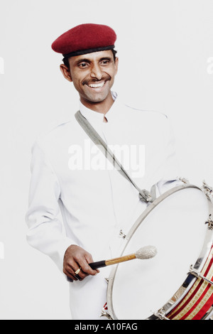 Mid adult man playing a drum Stock Photo