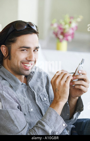 Portrait of a young man using a mobile phone with a digitized pen Stock Photo