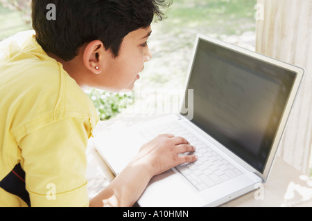 High angle view of a boy using a laptop Stock Photo