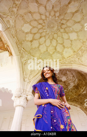 Low angle view of a young woman smiling, Agra Fort, Agra, Uttar Pradesh, India Stock Photo