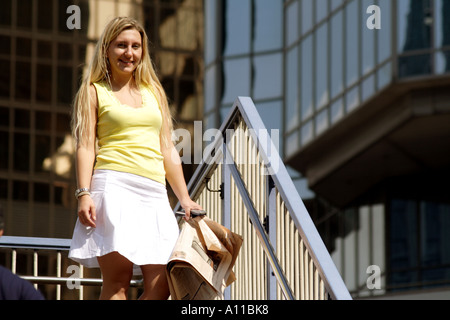 Financial pages in hand on a staircase in front of Lippo Center, Hong Kong, SAR Stock Photo