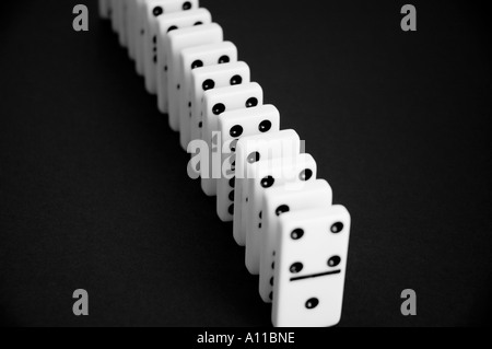 Dominos in a row on a black background Stock Photo