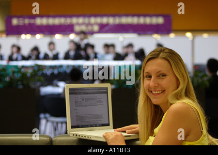 Student taking notes on a laptop computer at a University seminar Stock Photo