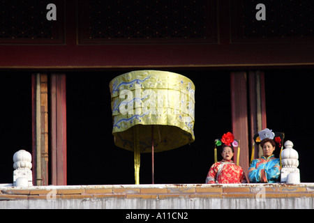 Actors in period costumes on a balcony at the Forbidden City, Beijing, China Stock Photo