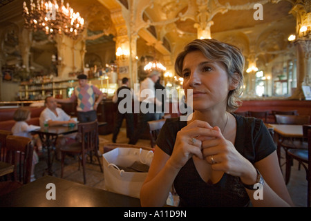 A young single Lady waiting in the 'Grand Cafe' of Moulins. Jeune femme patientant dans le 'Grand Café' de Moulins (France). Stock Photo